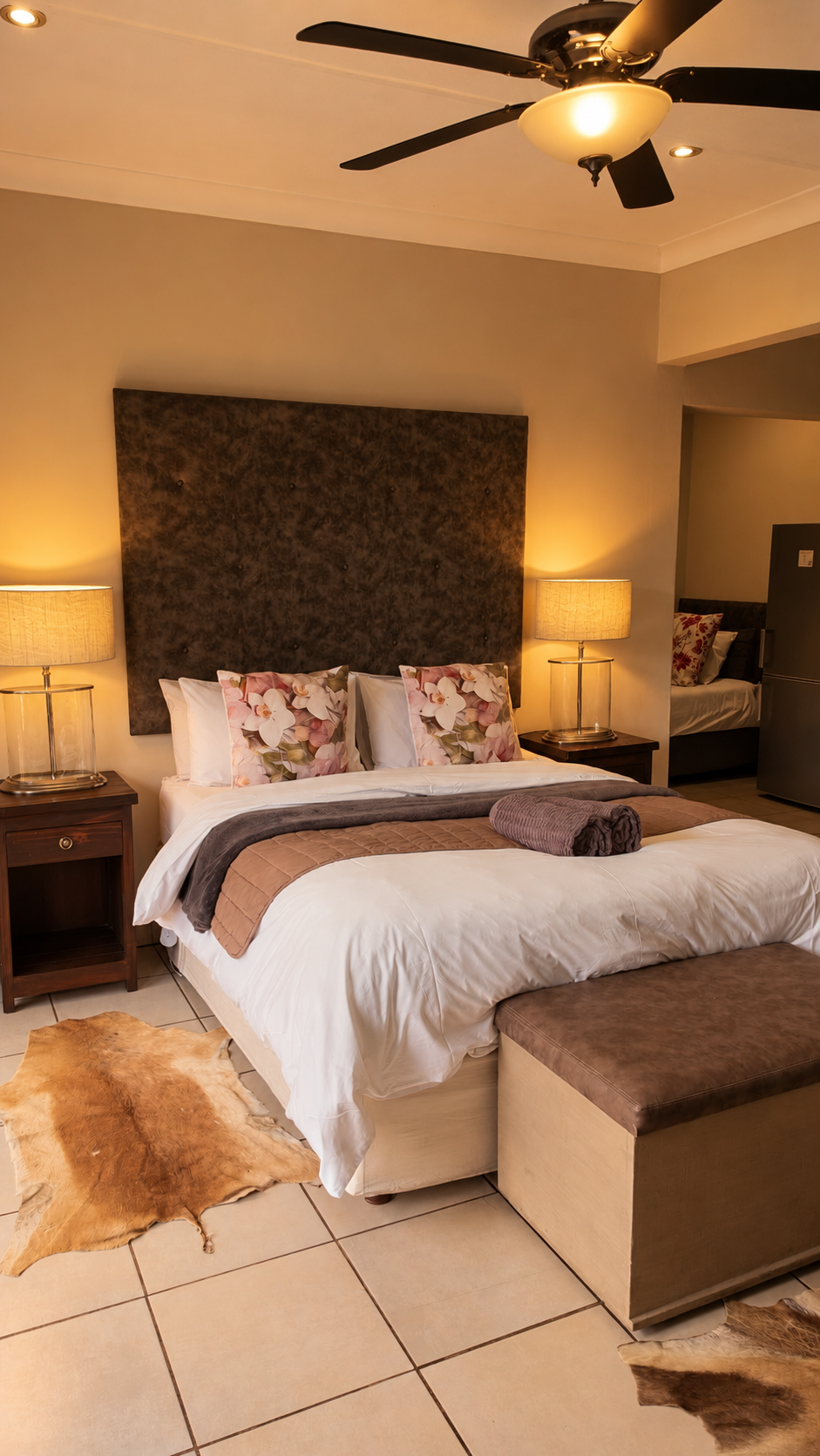 Room 6 with ceiling fan and cowhide rug at Big 5 Guesthouse
